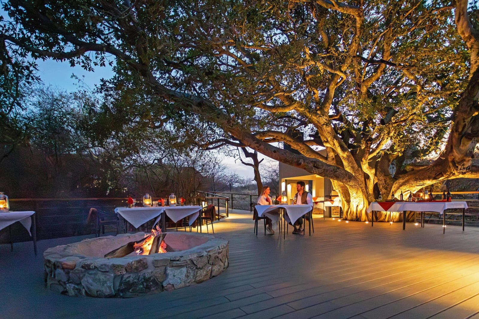 The boma fire pit and dining deck at dusk at Tuningi Safari Lodge.