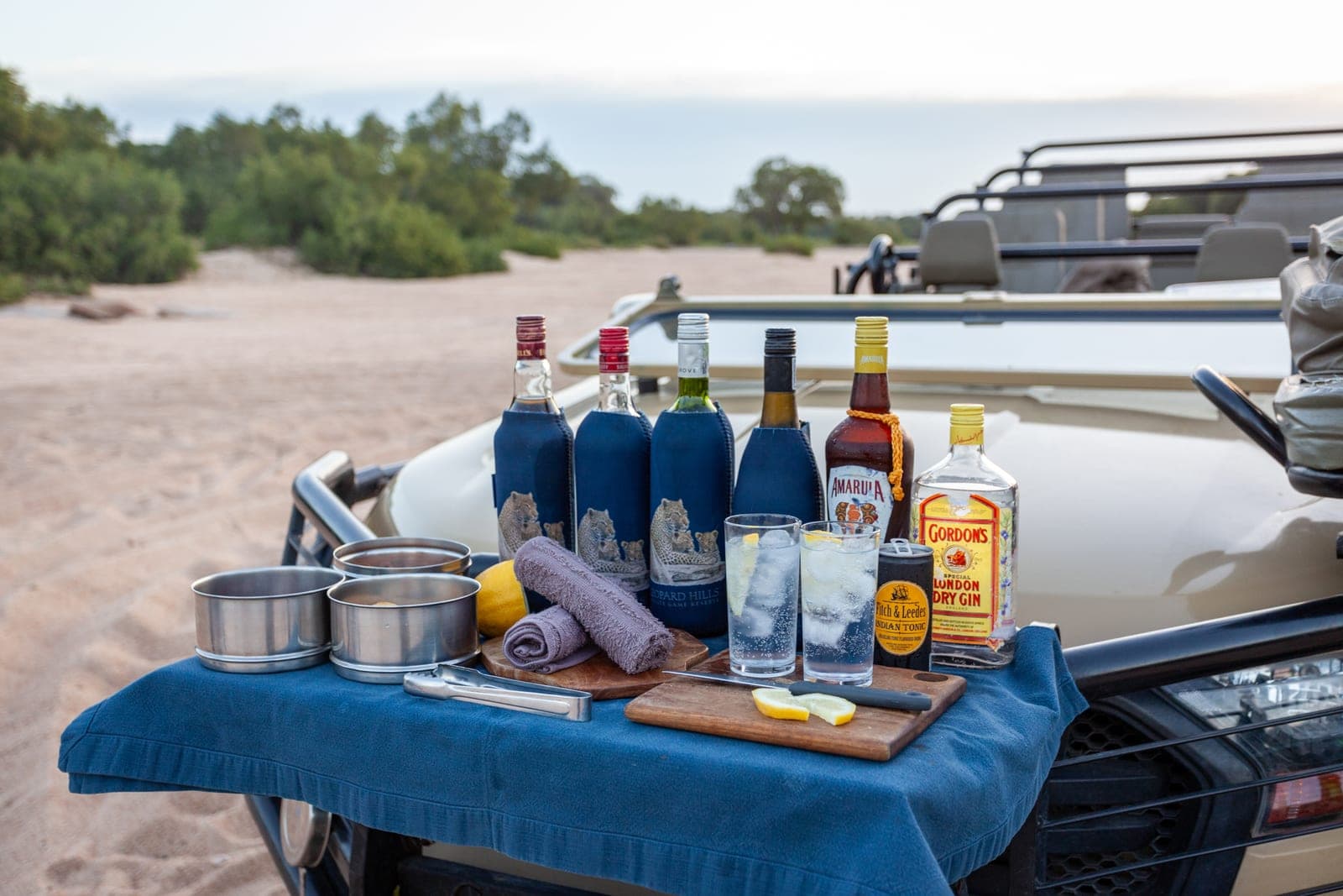 A sundowner drinks table set up beside the game vehicle at Leopard Hills.