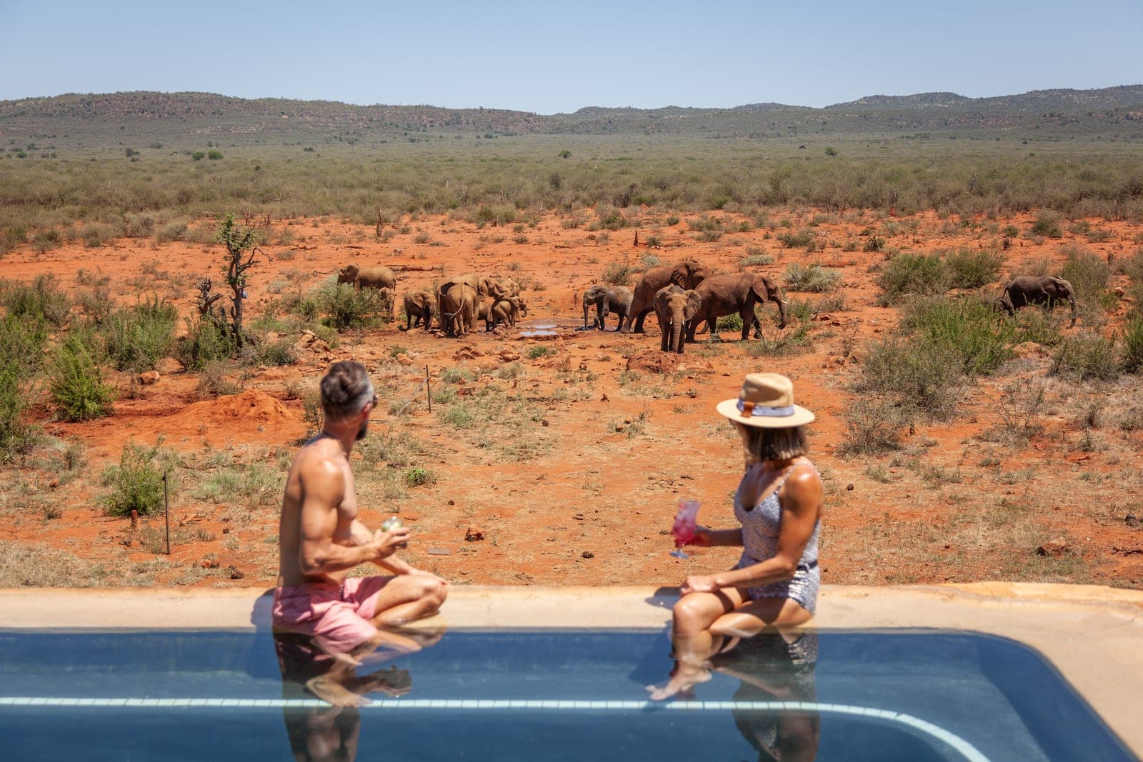 The pool deck at Madikwe Hills, with elephants at the waterhole beyond.