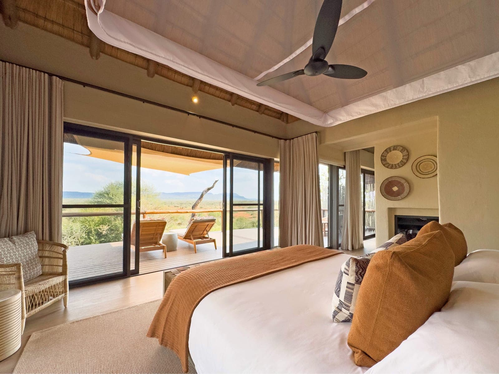 A suite bedroom opening onto a private deck at Madikwe Hills.