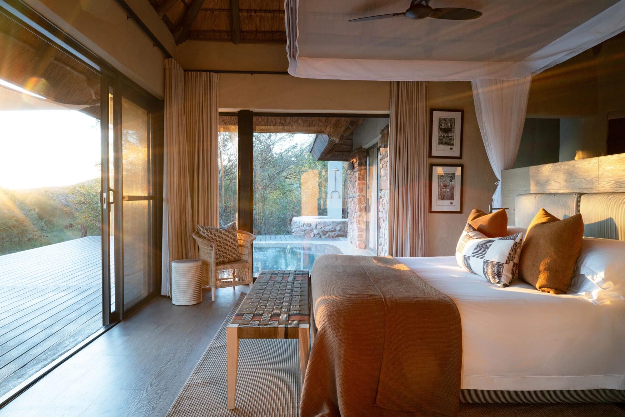 A glass-fronted luxury suite with private deck and plunge pool at Madikwe Hills.