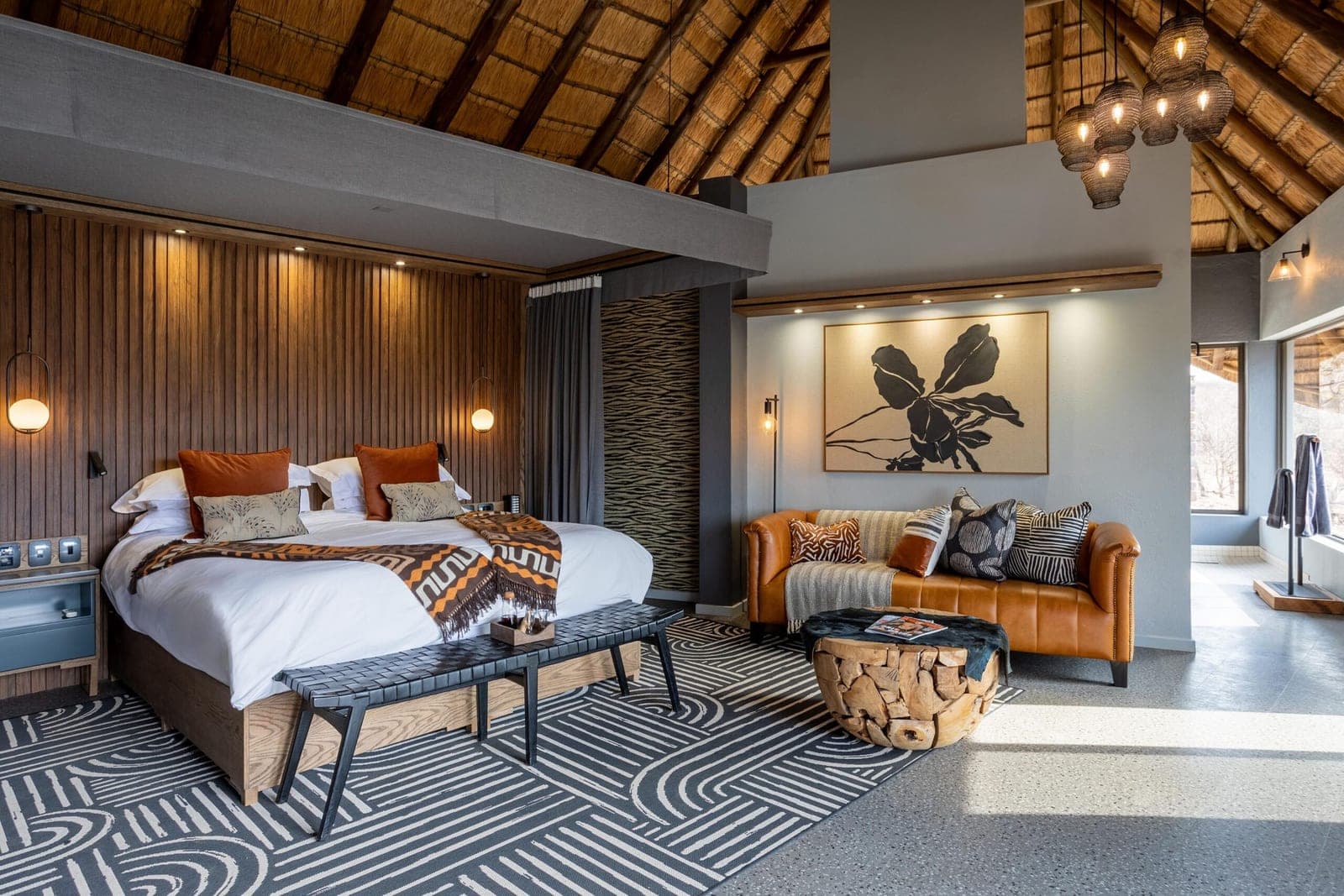 A thatched family-suite bedroom at Tuningi Safari Lodge.